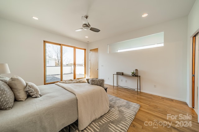 bedroom with ceiling fan, light wood-type flooring, and access to outside