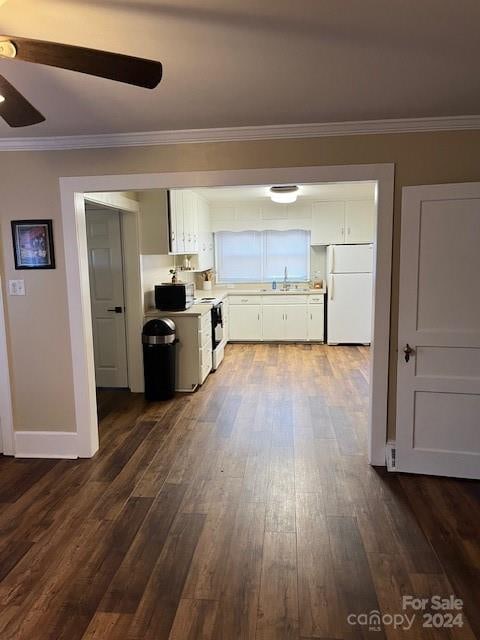 kitchen featuring white cabinetry, dark hardwood / wood-style floors, white refrigerator, stainless steel electric range, and ornamental molding