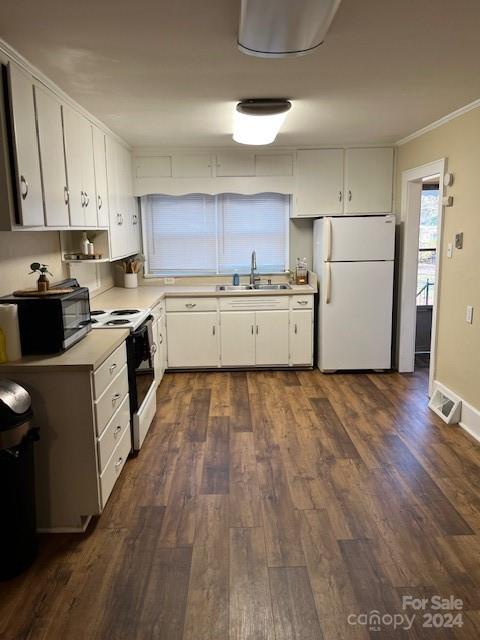 kitchen featuring white cabinets, dark hardwood / wood-style flooring, white appliances, and sink