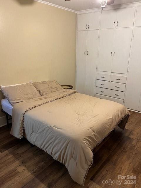 bedroom featuring dark hardwood / wood-style flooring and ornamental molding