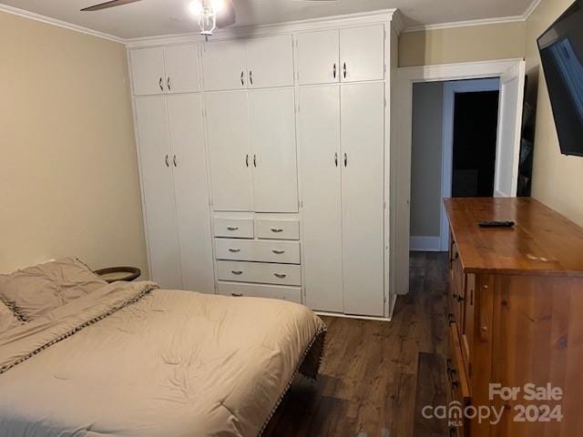 bedroom with ornamental molding, ceiling fan, and dark wood-type flooring