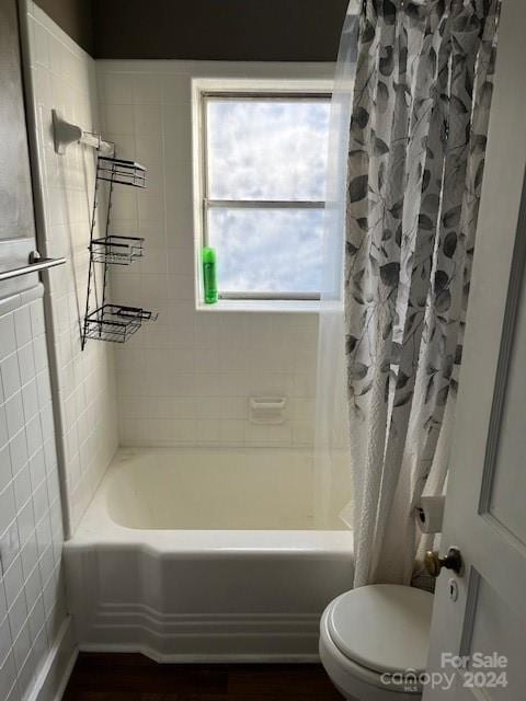 bathroom with shower / tub combo and toilet