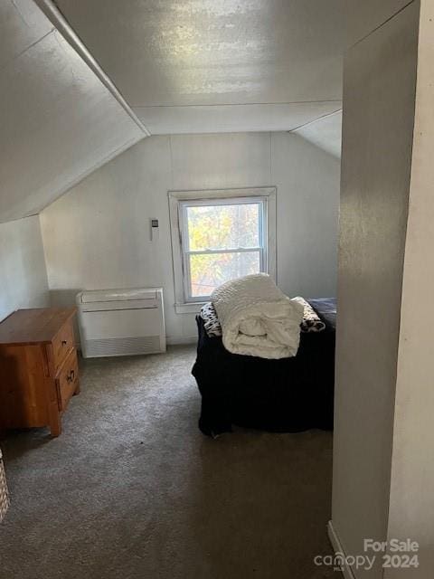 carpeted bedroom featuring vaulted ceiling