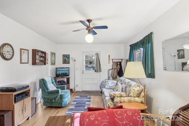 living room featuring ceiling fan and light hardwood / wood-style floors