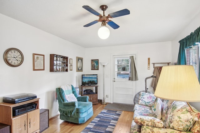 living room featuring ceiling fan and light wood-type flooring