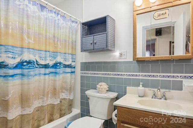 full bathroom with shower / tub combo, vanity, toilet, and tile walls