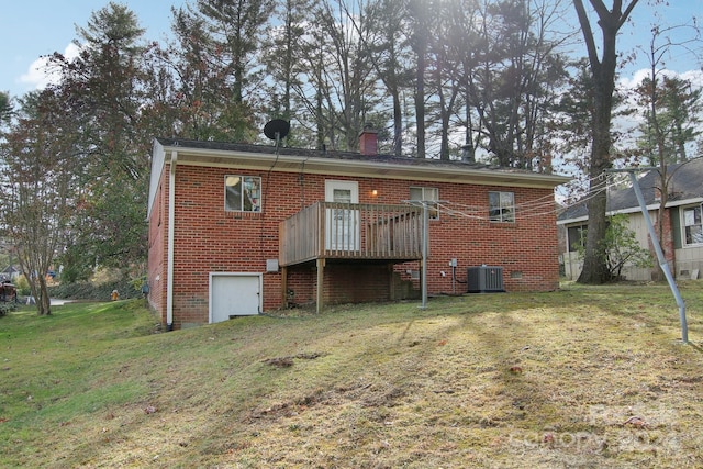 back of property with a lawn, central AC unit, and a deck