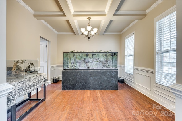 interior space with beam ceiling, hardwood / wood-style floors, coffered ceiling, and ornamental molding