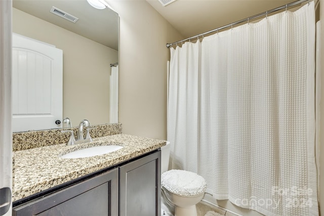 bathroom with tile patterned flooring, vanity, curtained shower, and toilet