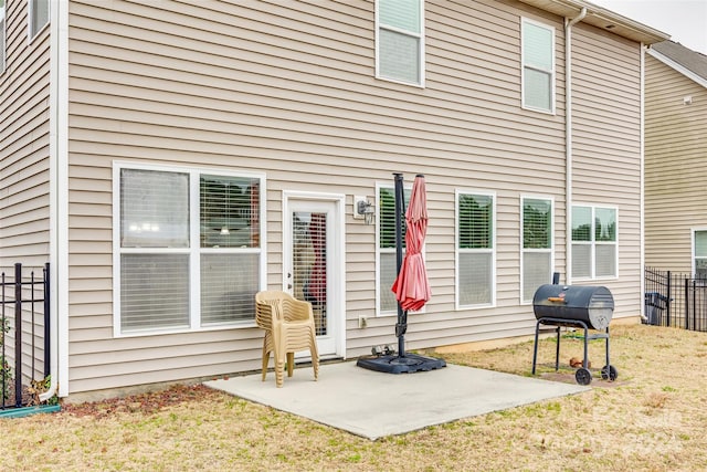 back of house featuring a patio and a lawn