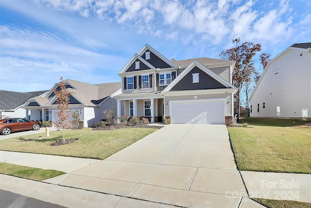 craftsman inspired home with a garage and a front yard