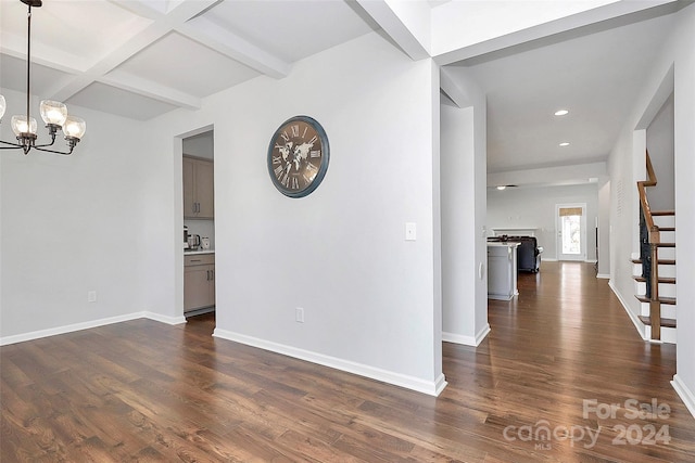 interior space with beam ceiling, dark wood-type flooring, and an inviting chandelier