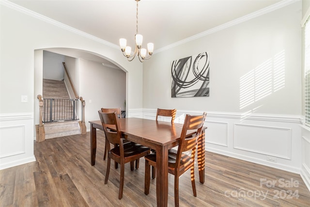 dining room featuring a chandelier, dark wood-type flooring, and ornamental molding