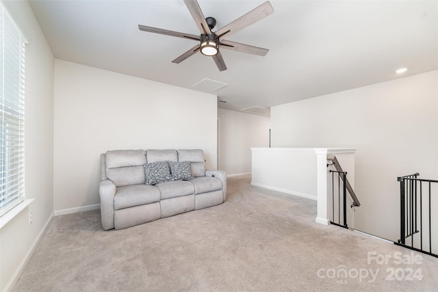 living room featuring light carpet and ceiling fan