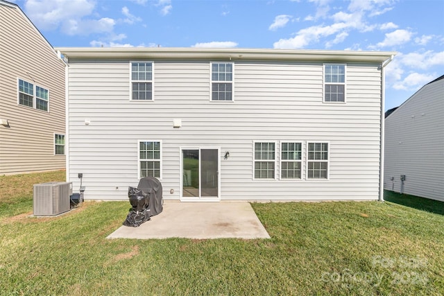 rear view of house with a yard, a patio, and central AC