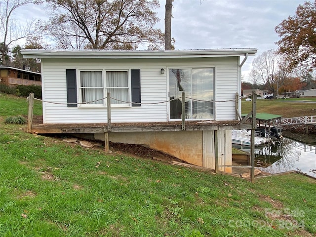 rear view of property featuring a yard