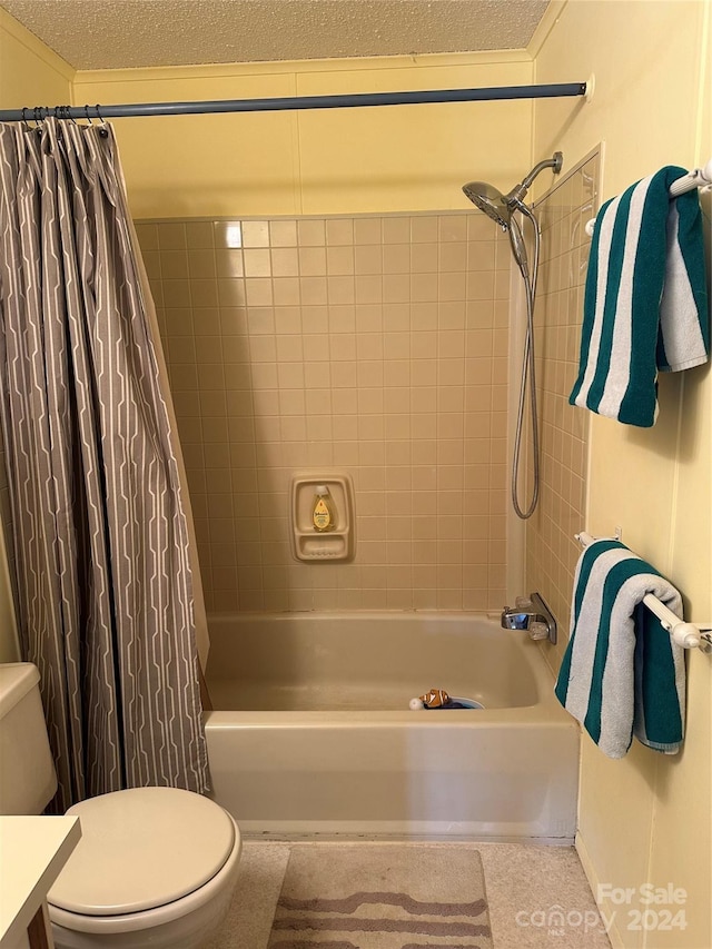 bathroom with shower / bathtub combination with curtain, a textured ceiling, and toilet