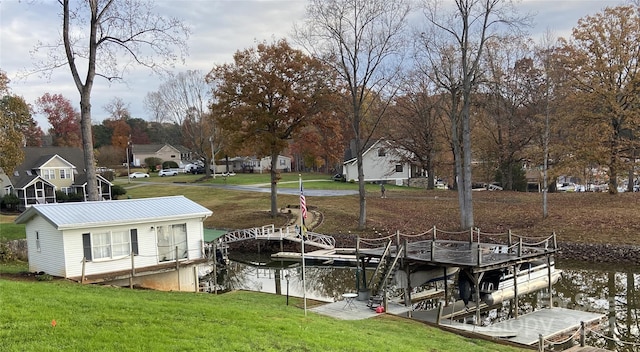 dock area featuring a lawn and a water view