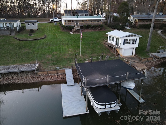 dock area with a yard and a water view