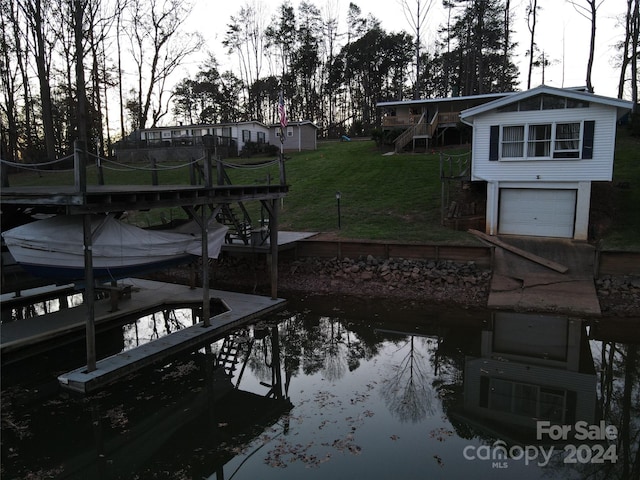 dock area featuring a lawn and a water view