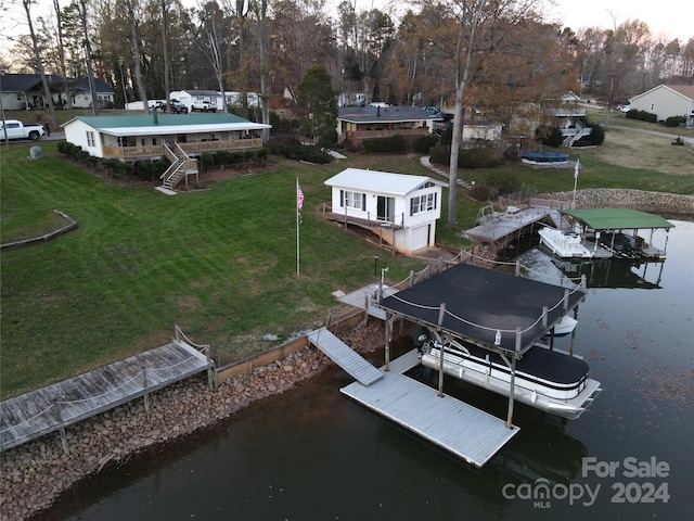 dock area with a yard and a water view