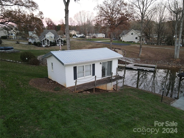 exterior space with a yard and a water view