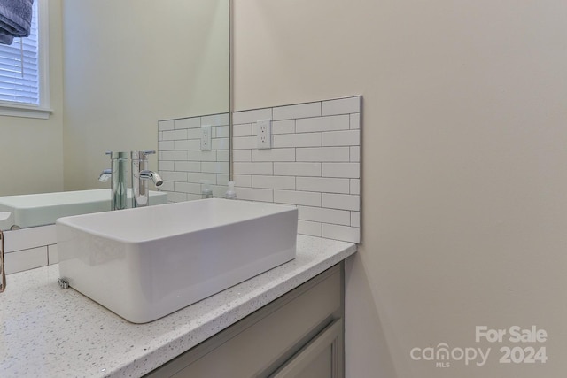 bathroom featuring decorative backsplash and vanity