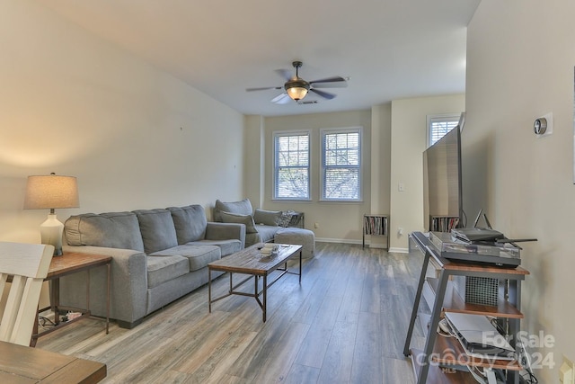 living room featuring ceiling fan and hardwood / wood-style floors