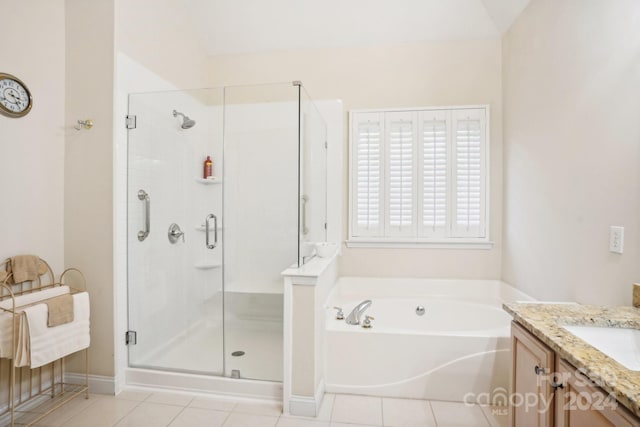 bathroom featuring tile patterned flooring, vanity, lofted ceiling, and plus walk in shower