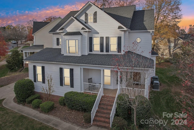 view of property with central AC unit and a porch