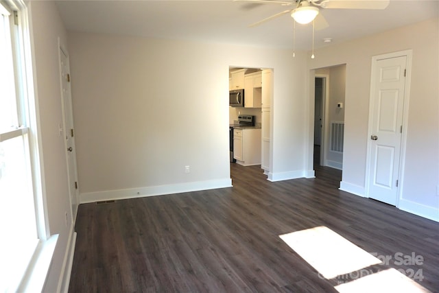 interior space featuring ceiling fan, dark hardwood / wood-style flooring, and a healthy amount of sunlight