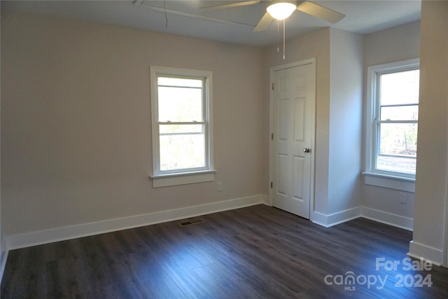 unfurnished room featuring ceiling fan and dark hardwood / wood-style floors