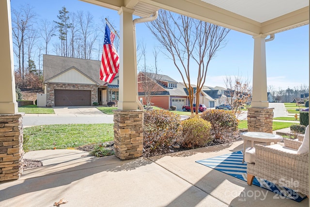 view of patio featuring covered porch and a garage