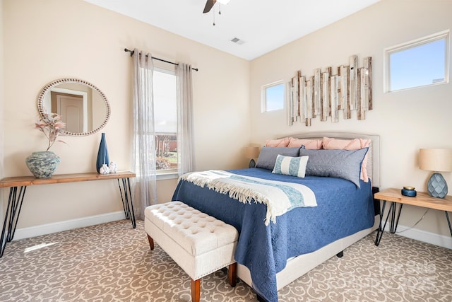 bedroom with multiple windows and ceiling fan