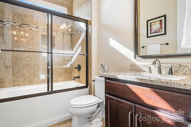 full bathroom featuring vanity, enclosed tub / shower combo, and toilet