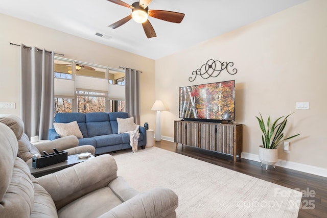 living room featuring dark hardwood / wood-style floors and ceiling fan