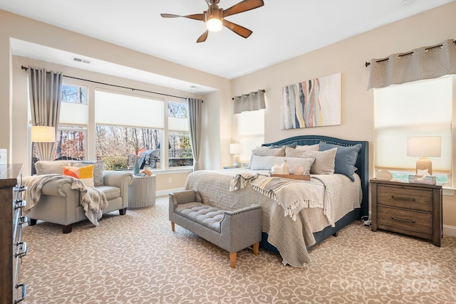 bedroom featuring multiple windows and ceiling fan