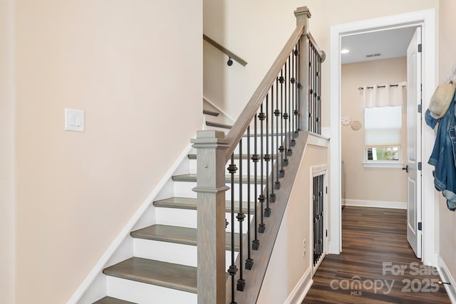 stairs featuring wood-type flooring