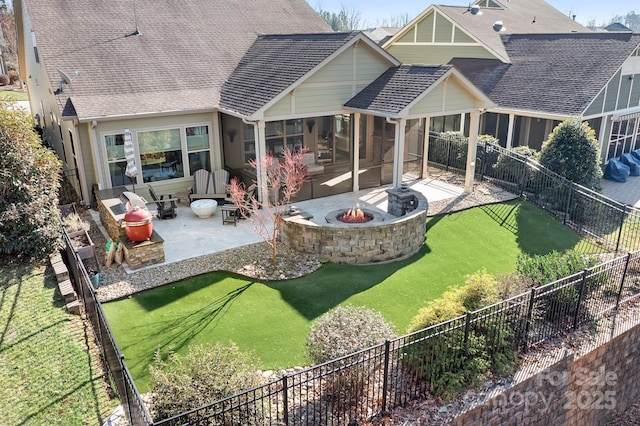 rear view of house featuring a patio area, a sunroom, a yard, and an outdoor living space with a fire pit