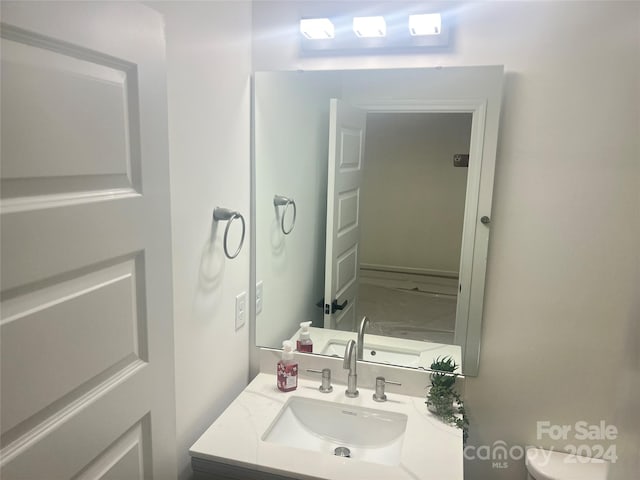 bathroom featuring vanity and toilet