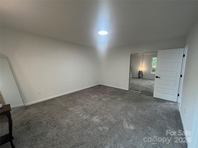 unfurnished bedroom featuring dark colored carpet