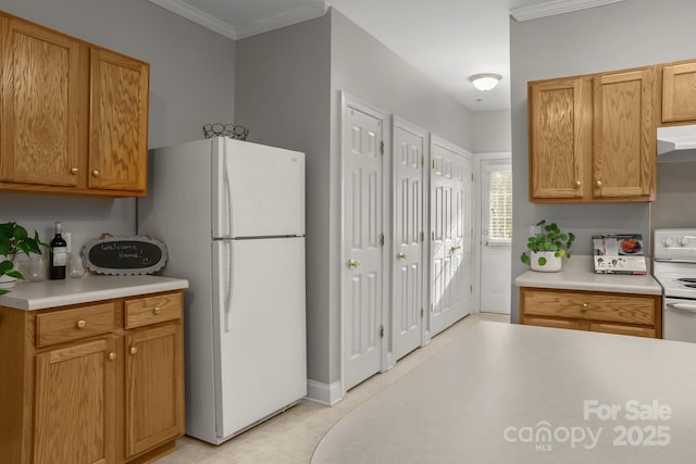 kitchen featuring white appliances, crown molding, and range hood