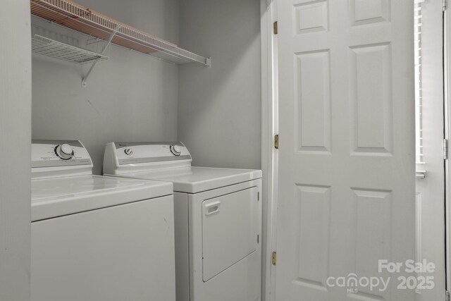 clothes washing area with washing machine and clothes dryer