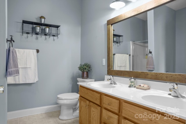 bathroom with a shower with door, vanity, and toilet