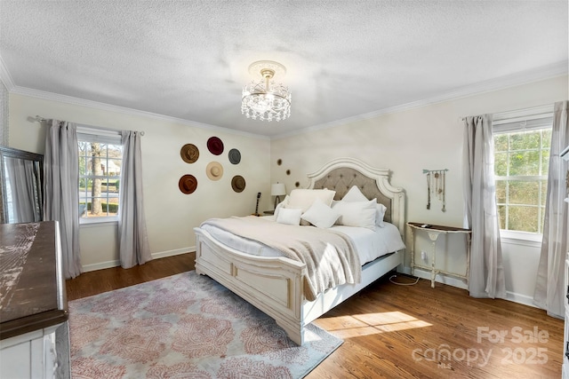 bedroom with light wood-style floors, multiple windows, and a textured ceiling