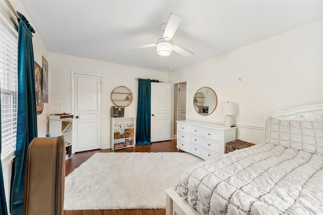 bedroom with ceiling fan and dark wood finished floors