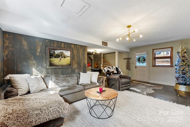 living room featuring baseboards and stairs