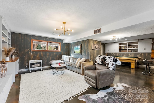 living room with heating unit, visible vents, concrete flooring, and a textured ceiling