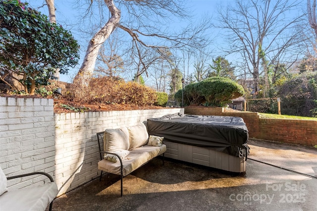 view of patio / terrace with a hot tub