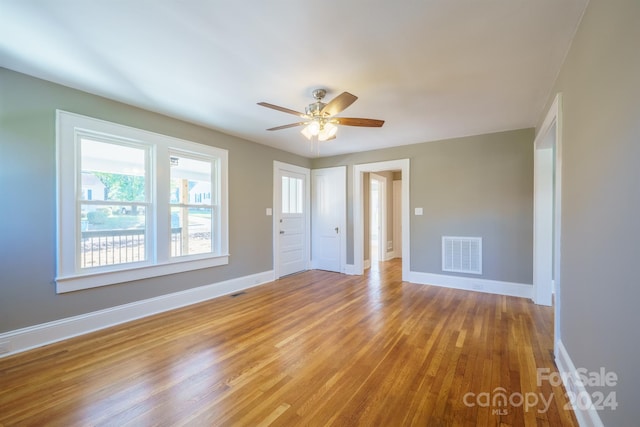 unfurnished room featuring ceiling fan and light wood-type flooring